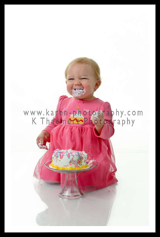 Photo of a 1 year old girl with her birthday cake St Charles Baby Photography