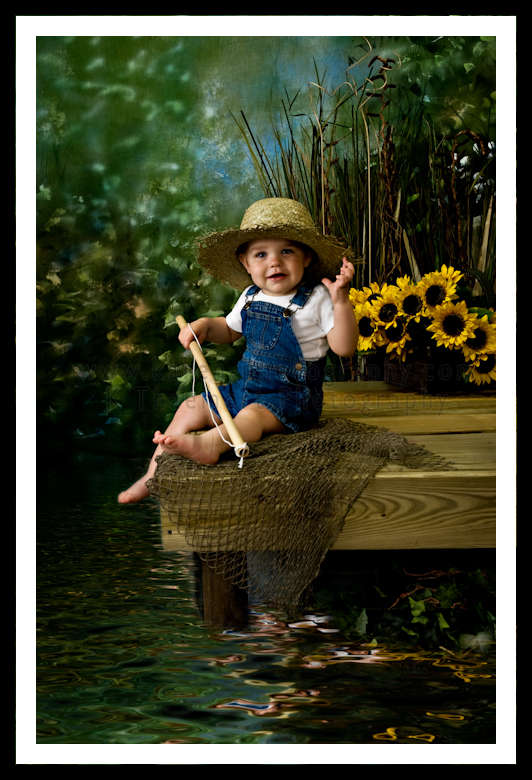 Toddler Boy with fishing pole, straw hat, on pier